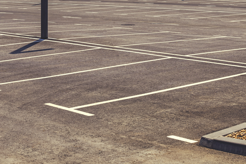 VistaCreate-163048194-stock-photo-empty-parking-lot-with-marked-parking-field